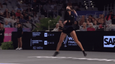 Woman In Black Dress Playing Tennis In Front Of Sap Sign GIF