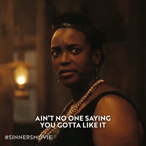 Woman In Black Dress Saying Ain't No One Saying You Gotta Like It GIF