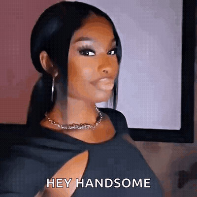 Woman In Black Dress Saying Hey Handsome GIF
