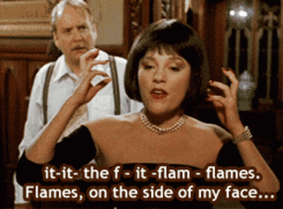 Woman In Black Dress Saying It-It-The-F-It-Flam-Flames GIF