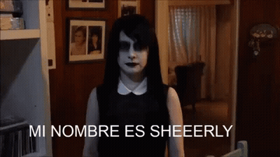 Woman In Black Dress Saying Mi Nombre Es Sheeerly GIF