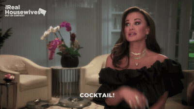 Woman In Black Dress Says Cocktail Real Housewives Sign GIF