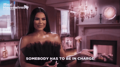 Woman In Black Dress Says Somebody Has To Be In Charge GIF