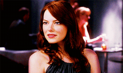 Woman In Black Dress Sitting In Red Chair Mouth Open GIF