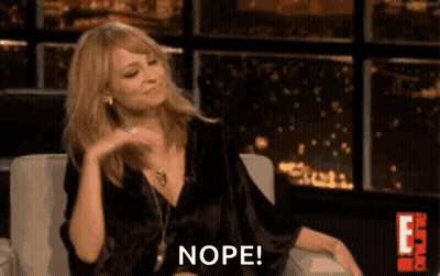 Woman In Black Dress Sitting Making Funny Face Saying Nope GIF