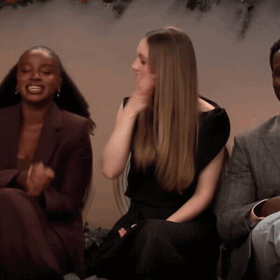 Woman In Black Dress Sitting Next To Two Women GIF