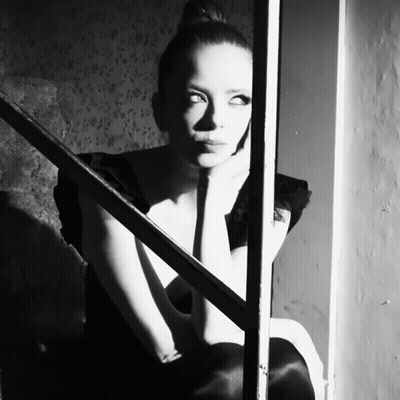 Woman In Black Dress Sitting On Stairs GIF