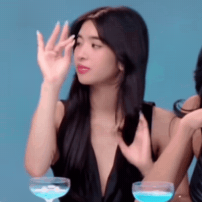 Woman In Black Dress Sitting With Wine GIF