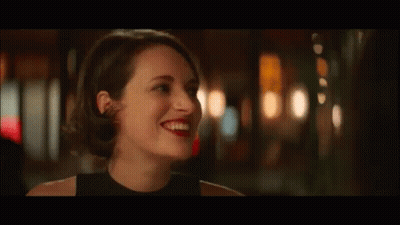 Woman In Black Dress Smiling At Another Woman GIF
