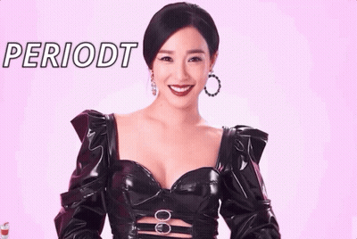Woman In Black Dress Smiling At Periodt Sign GIF