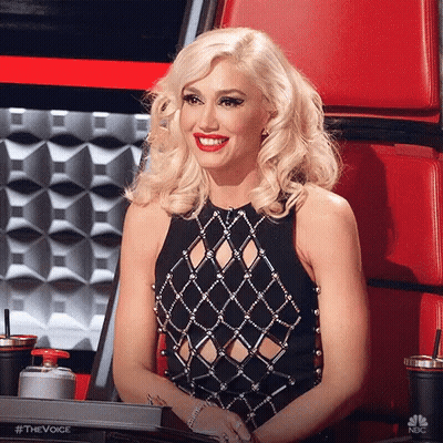 Woman In Black Dress Smiling In Red Chair GIF