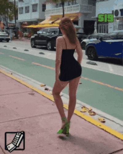 Woman In Black Dress Standing By S19 Sign GIF