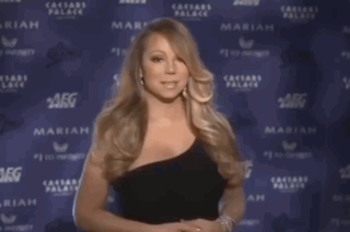 Woman In Black Dress Standing In Front Of Wall Saying Caesars Palace GIF