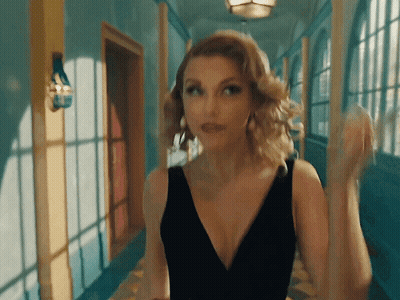 Woman In Black Dress Standing In Hallway GIF