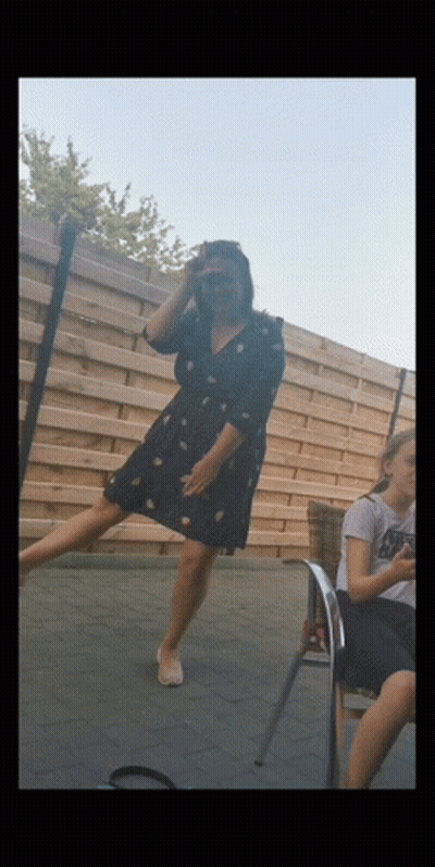 Woman In Black Dress Standing On One Leg GIF