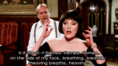 Woman In Black Dress Talking About Flames GIF