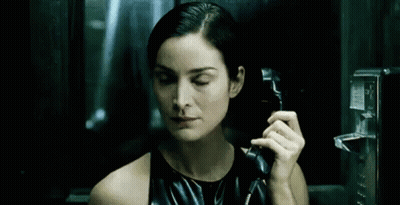 Woman In Black Dress Talking On Pay Phone GIF