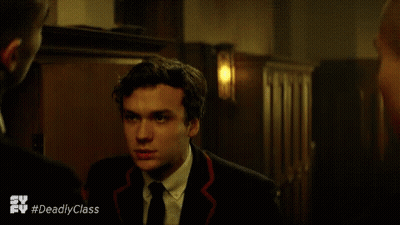 Woman In Black Dress Talking To Man In White Shirt And Suspenders GIF