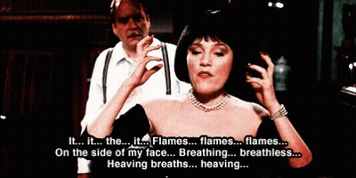 Woman In Black Dress Talking To Man In White Shirt And Suspenders GIF