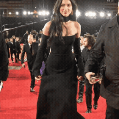 Woman In Black Dress Walking On Red Carpet GIF