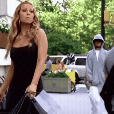 Woman In Black Dress Walking With Shopping Bags GIF