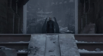 Woman In Black Dress With Man Behind At Castle GIF