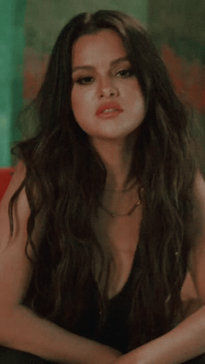 Woman In Black Dress With Plunging Neckline GIF