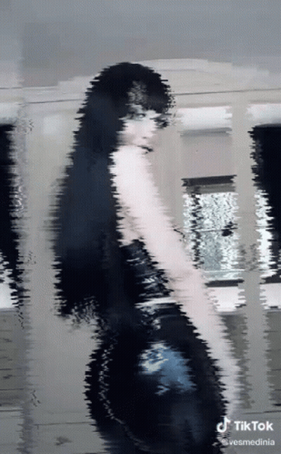 Woman In Black Dress With TikTok Watermark GIF