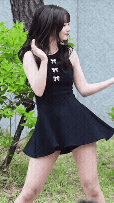 Woman In Black Dress With White Bows GIF