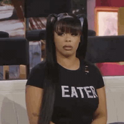 Woman In Black Eater Shirt On Couch GIF