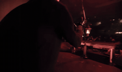 Woman In Black Gloves Sings Into Microphone GIF