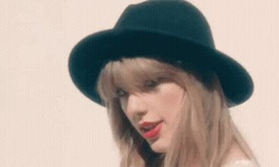 Woman In Black Hat And Red Lipstick Looking At Camera GIF