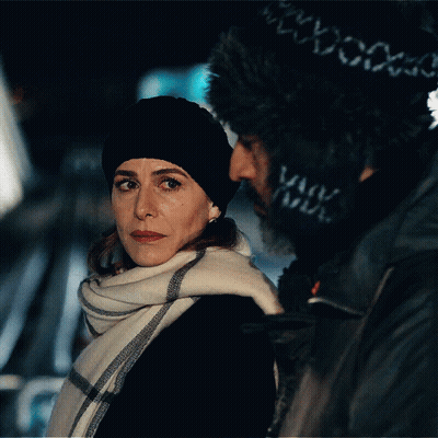 Woman In Black Hat And Scarf Next To Man GIF