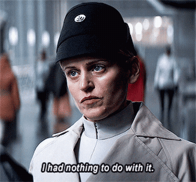 Woman In Black Hat And Trench Coat Says I Had Nothing To Do With It GIF