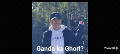 Woman In Black Hat And White Hoodie Standing In Front Of Trees GIF