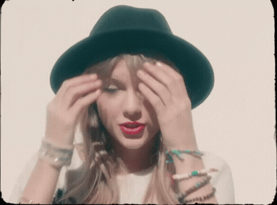 Woman In Black Hat Covering Eyes GIF