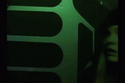 Woman In Black Hat In Dark Room GIF