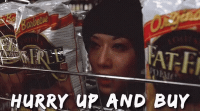 Woman In Black Hat Looking At Fat-Free Chips GIF
