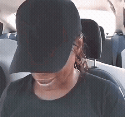 Woman In Black Hat Smiling In Back Seat Of Car GIF