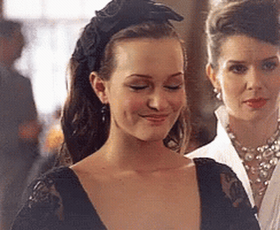 Woman In Black Headband And Earrings Smiling GIF