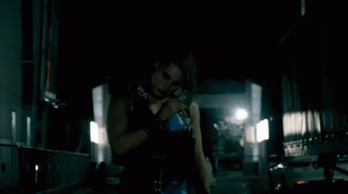 Woman In Black Holding Blue Bottle GIF