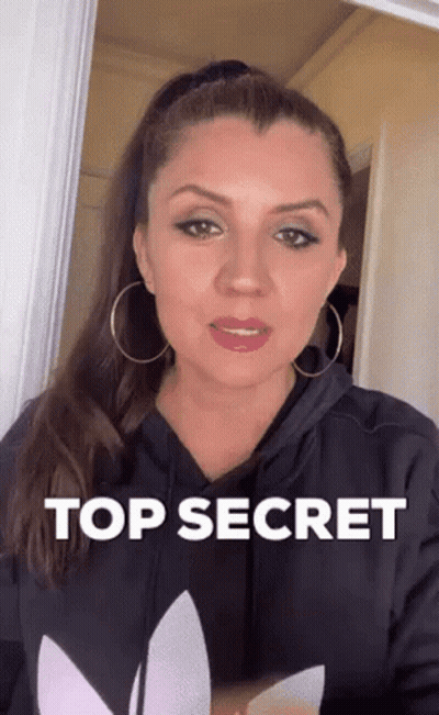 Woman In Black Hoodie And Hoop Earrings Says Top Secret GIF
