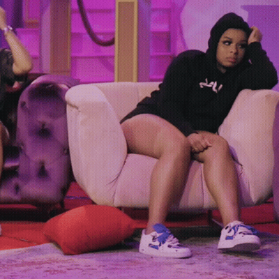 Woman In Black Hoodie Sitting On White Couch GIF