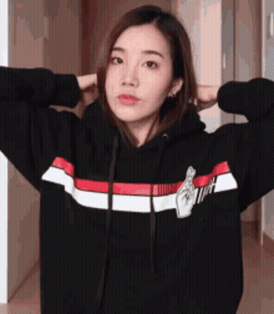 Woman In Black Hoodie With Red And White Stripes Stretching Arms GIF