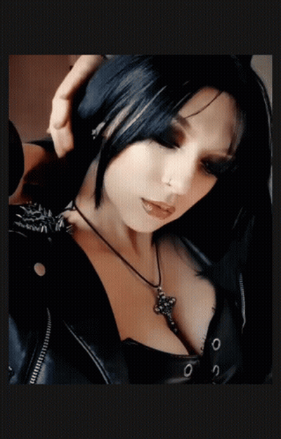 Woman In Black Jacket And Cross Necklace GIF