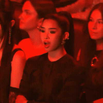 Woman In Black Jacket And Earrings In Dark Room GIF