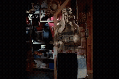 Woman In Black Jacket And White Shirt Standing In Room GIF