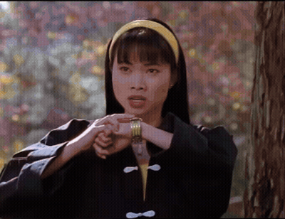 Woman In Black Jacket And Yellow Headband Holding Hands Together GIF