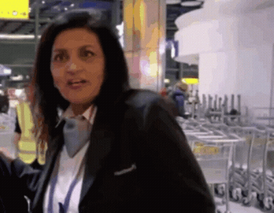 Woman In Black Jacket At Carts Marked G GIF