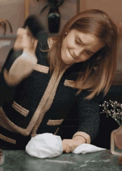 Woman In Black Jacket Cleaning Table GIF
